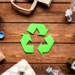 a green recycling symbol surrounded by recyclable materials