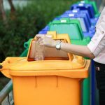 A women recycling her water bottle