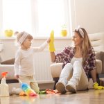 mother teaching her young daughter how to spring clean