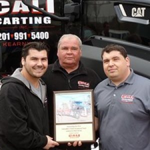 3 males holding sign