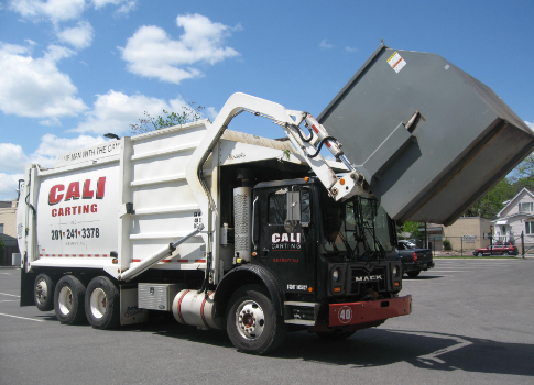 Trash being loaded into garbage truck