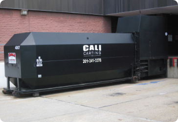 Compactor outside of business