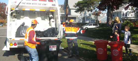 Men filling garbage truck