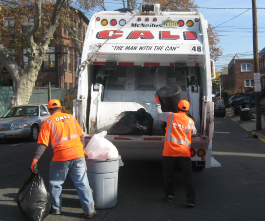 Men filling garbage truck