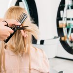 Blonde woman getting a haircut in hair salon